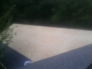 New OSB roof sheathing installed beside an existing shingle roof in Mililani